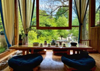 a living room with a table and chairs