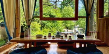 a living room with a table and chairs